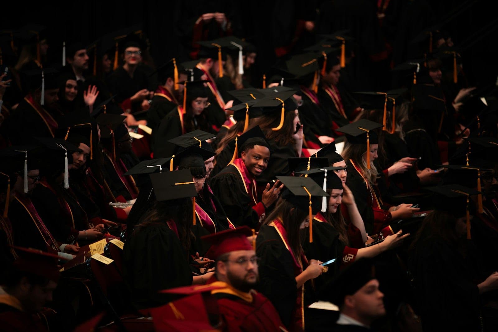 Graduates in caps and gowns throwing their caps at the end of a ceremony